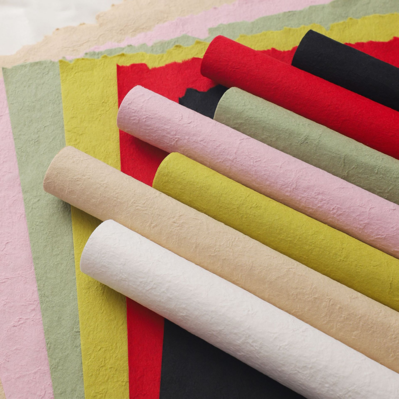 Pink floral wrapping paper with hand-torn edges.