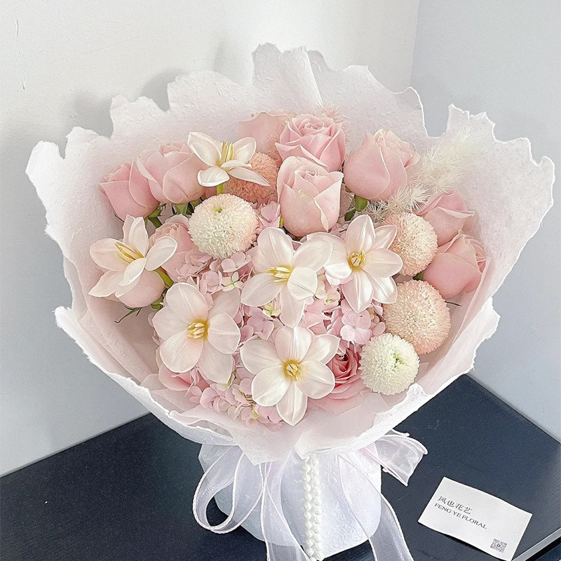 Pink floral wrapping paper with hand-torn edges.