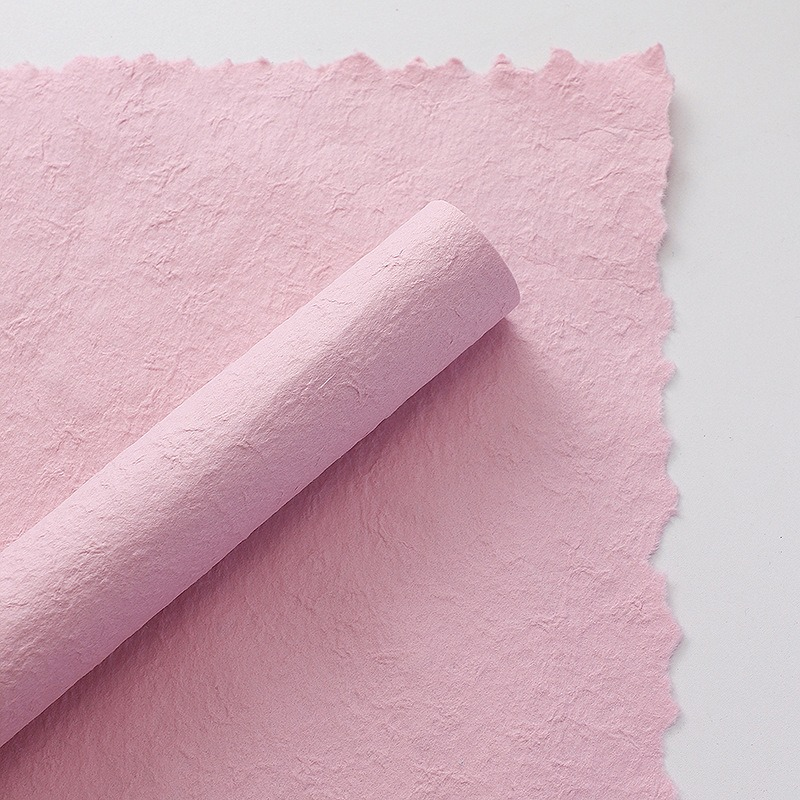 Pink floral wrapping paper with hand-torn edges.