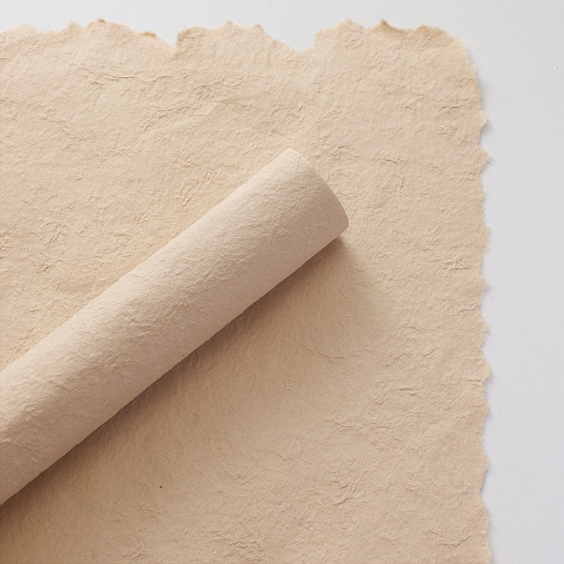 Pink floral wrapping paper with hand-torn edges.