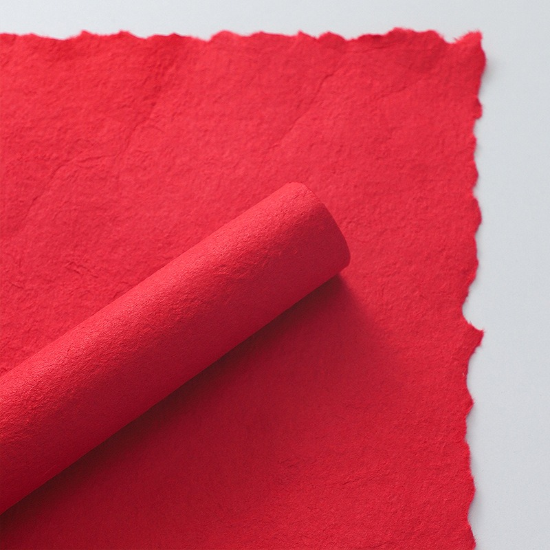 Pink floral wrapping paper with hand-torn edges.