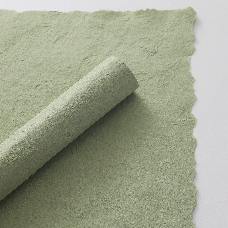 Pink floral wrapping paper with hand-torn edges.